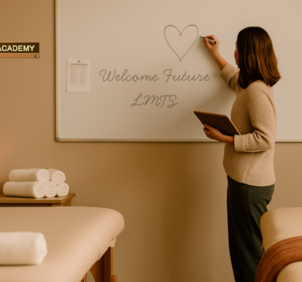 Massage therapy instructor writing on a whiteboard that says ‘Welcome Future LMTs’ in a warm classroom at Texas Massage Academy, with massage tables, rolled towels, a candle, and a potted plant creating a cozy and inviting atmosphere.