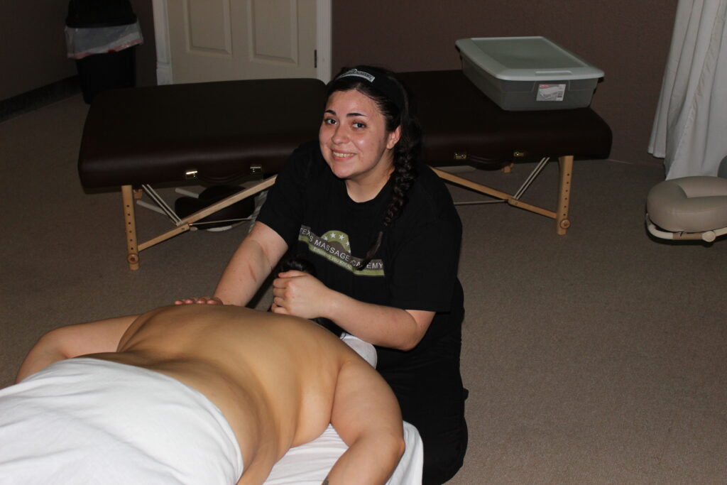Sarah Suarez giving a therapeutic massage during her training at Texas Massage Academy